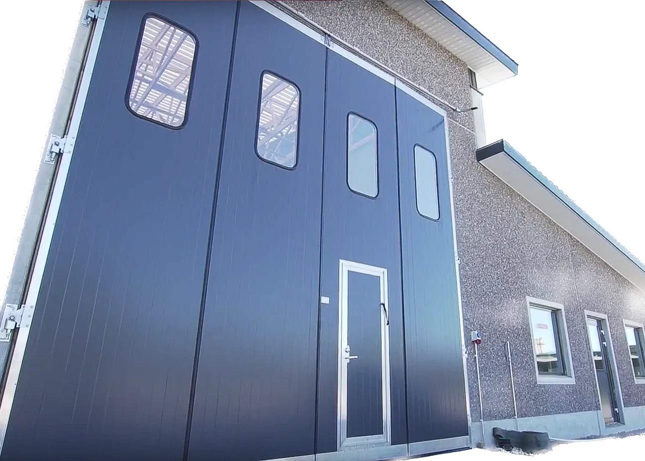 Tall overhead doors on a blue steel farm and commercial building