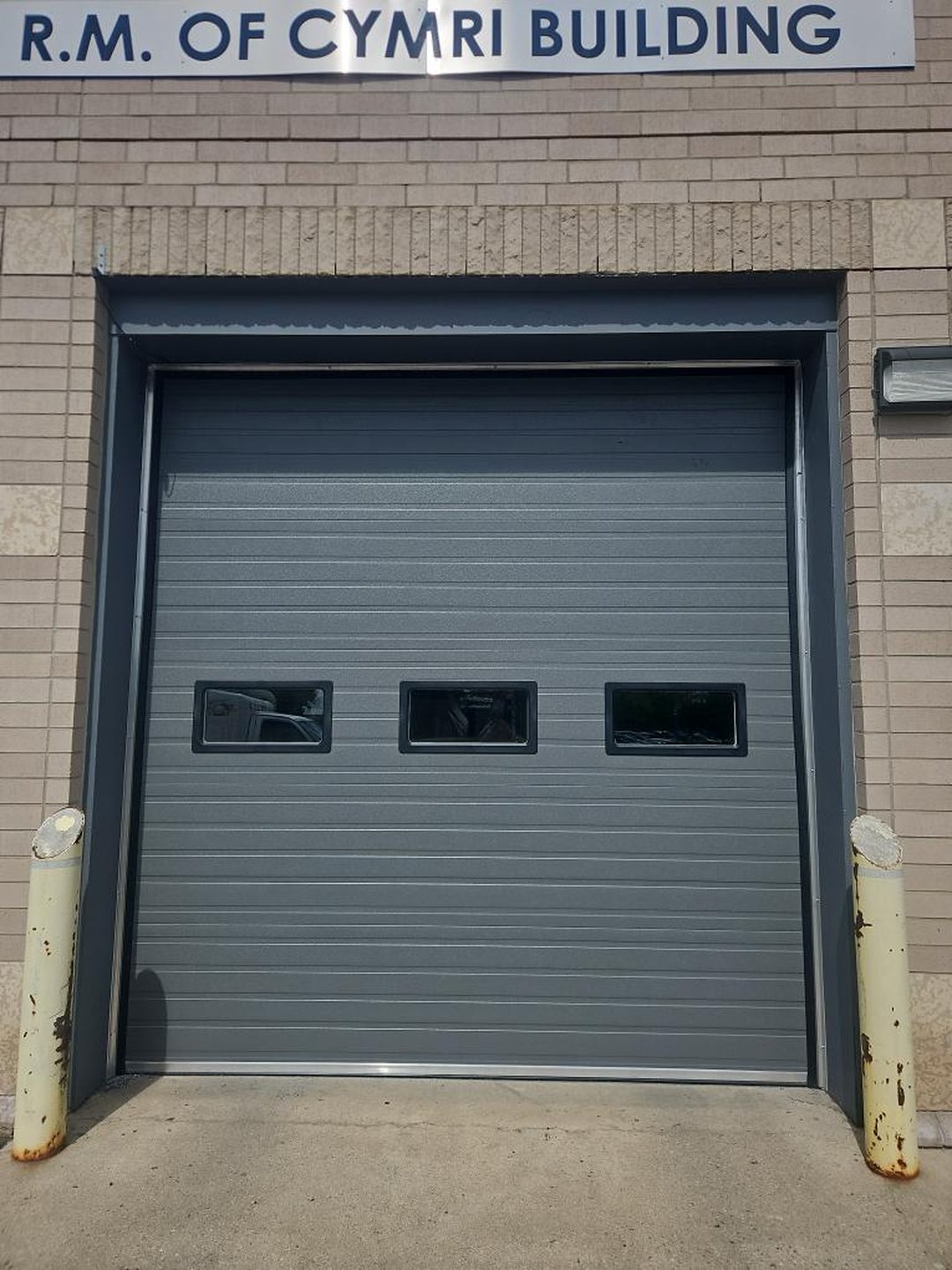 Grey sectional overhead door on a municipal building