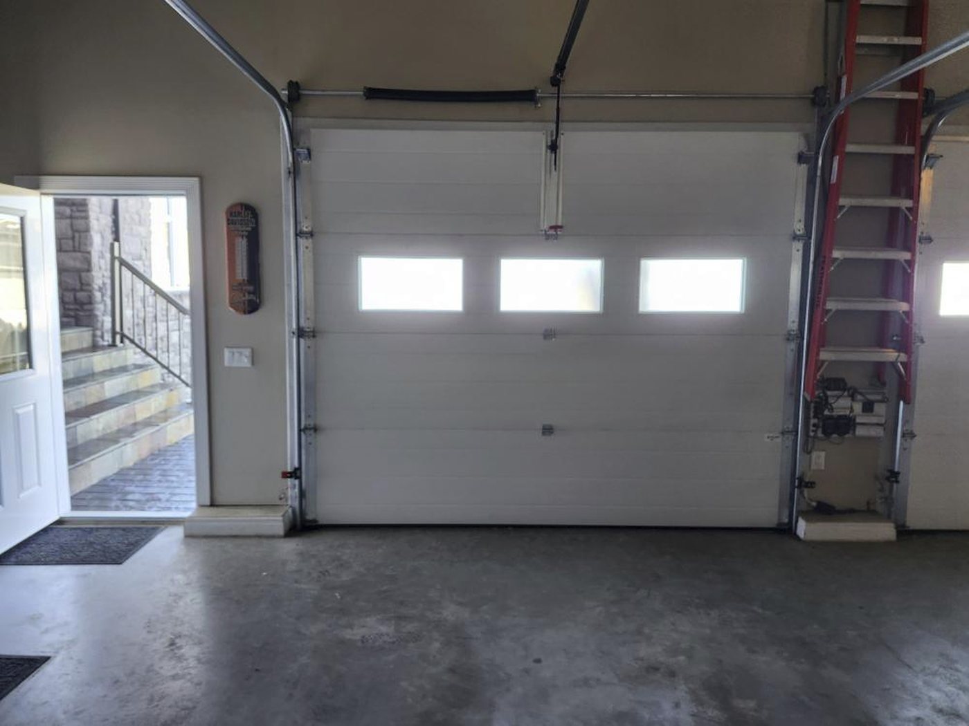 White sectional garage door with windows from inside a garage