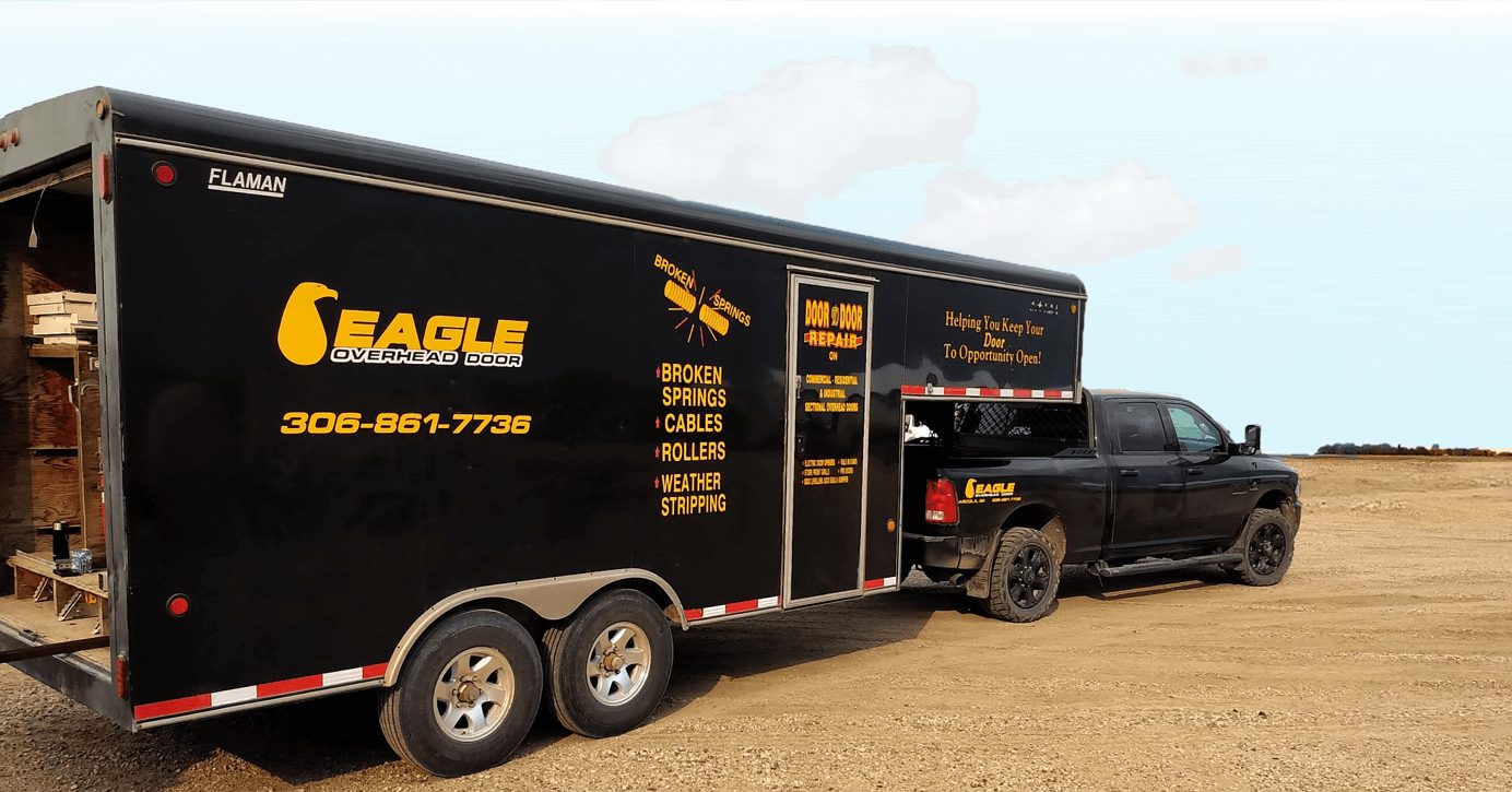Eagle Overhead Door service truck and trailer at a Saskatchewan job site